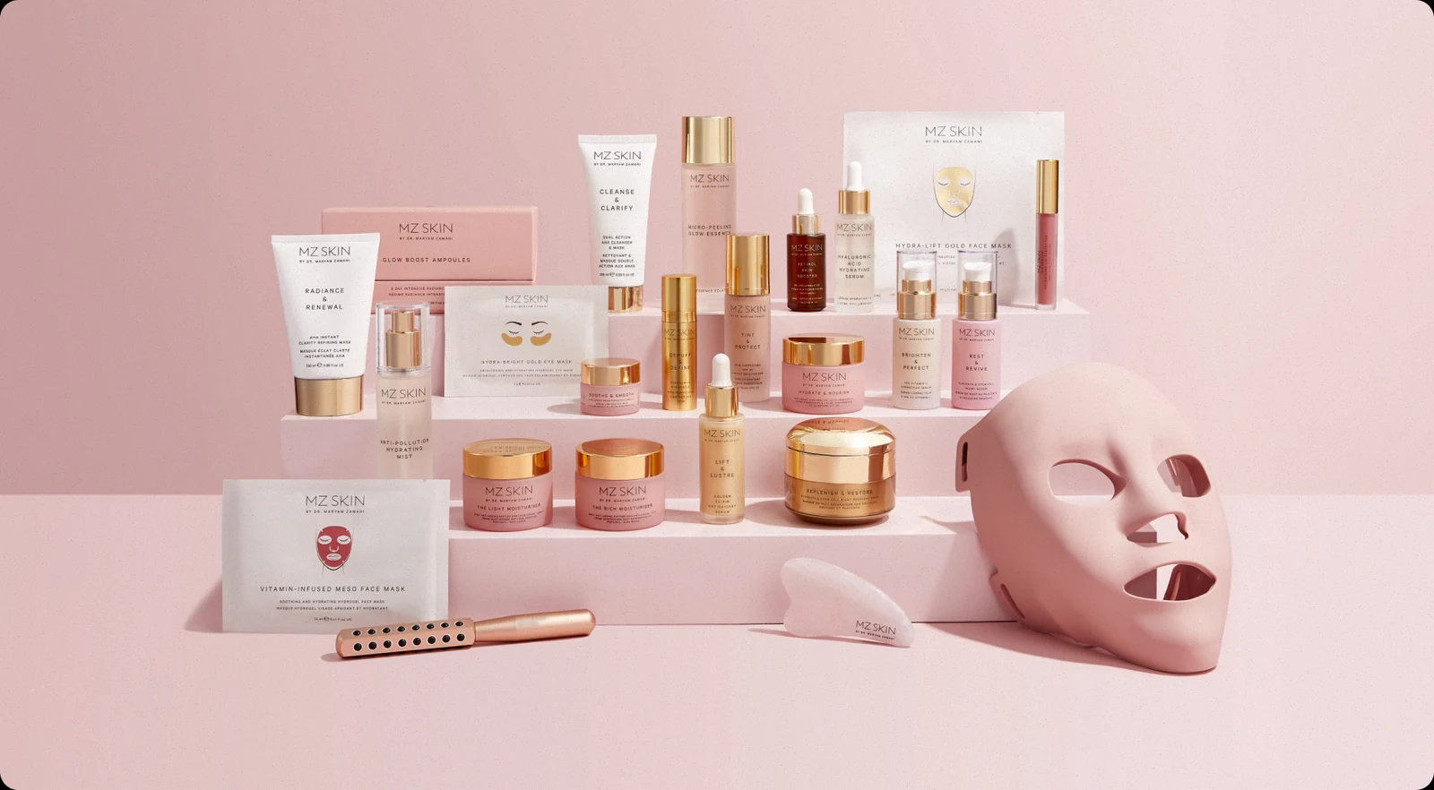 The MZSkin range of skincare, masks and tools arranged on pink steps